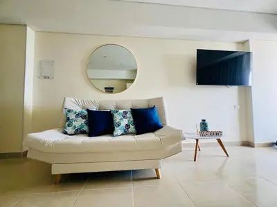 a living room with a couch and a mirror at Beautiful Studio close to the beach in Cartagena de Indias