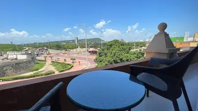 a table and chairs on a balcony with a view at Nautilus urban loft in Cartagena de Indias