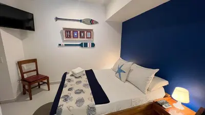 a bedroom with a bed with a blue wall at Nautilus urban loft in Cartagena de Indias