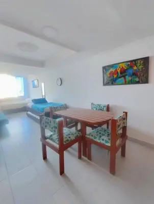a dining room with a table and chairs and a bed at Cartagena in Cartagena de Indias