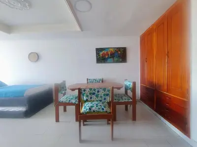 a bedroom with a table and two chairs and a bed at Cartagena in Cartagena de Indias