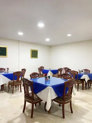 a dining room with blue tables and chairs at Hotel Continental Plaza Barranquilla in Barranquilla