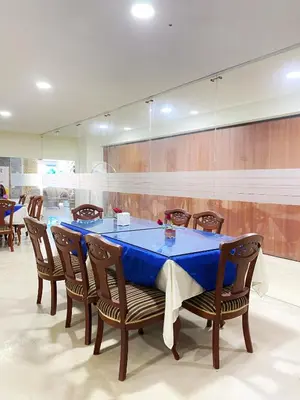 a dining room with a blue table and chairs at Hotel Continental Plaza Barranquilla in Barranquilla