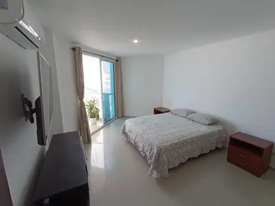 a white bedroom with a bed and a window at Apartamento en Los Morros - Cartagena de Indias in Cartagena de Indias