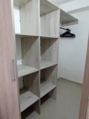 a white book shelf in a room at Jardín de Díos in Santa Marta
