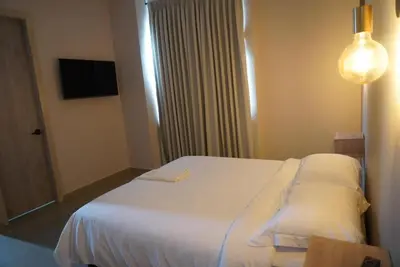 a bedroom with a white bed in a room at Casa Rio in Mangue