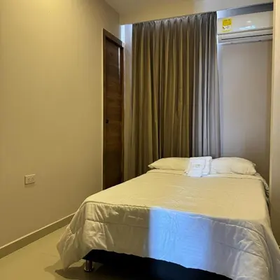 a bedroom with a large bed with a window at Casa Rio in Mangue