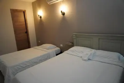 two beds sitting next to each other in a room at Casa Rio in Mangue
