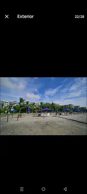 a picture of a beach with umbrellas on the sand at Apartamento Cartagena Serena del Mar - Capriella in Manzanillo del Mar