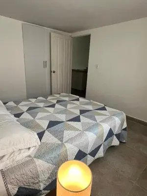 a bedroom with a bed with a checkered blanket at Apartamento en ciudad amurallada centro histórico Cartagena de Indias, Colombia in Cartagena de Indias