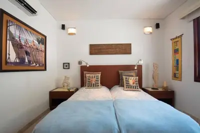 a bedroom with two beds with blue sheets and lamps at Luxury Apartment Private Pool & Rooftop Jacuzzi in Cartagena de Indias