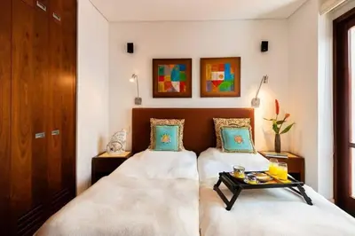 a bedroom with two beds and a table at Luxury Apartment Private Pool & Rooftop Jacuzzi in Cartagena de Indias