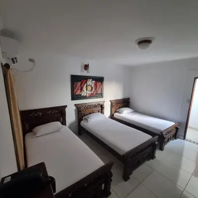 a room with three beds in a room at Hotel Cartagena Comfort in Cartagena de Indias