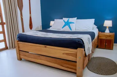 a bedroom with a bed with a blue wall at Loft with view 7 rooms in Cartagena de Indias