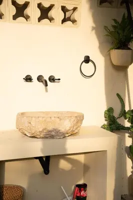 a bathroom with a stone sink on a counter at Almare Beach House Cartagena in Cartagena de Indias
