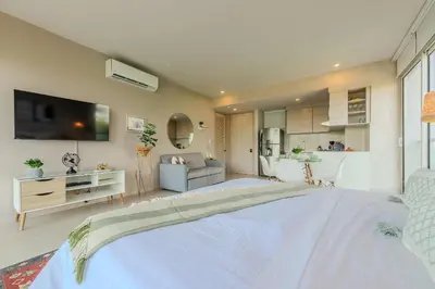 a large bedroom with a large bed and a kitchen at Condominio frente al mar con acceso directo a la playa Morros IO in Cartagena de Indias
