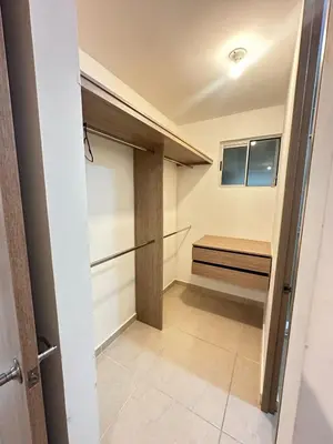 a walk in closet with a bench in a room at MY lOVE BARRANQUILLA 1 in Barranquilla