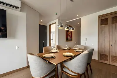 a dining room with a wooden table and chairs at NEW Panoramic view, Infinite Pool/Historic Center in Cartagena de Indias