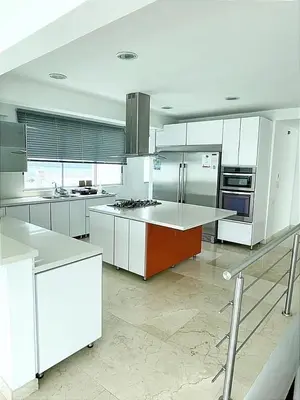 a large kitchen with white cabinets and a counter top at Lujoso Penthouse Duplex 403m2 con Terraza Privada y vista al mar in Cartagena de Indias