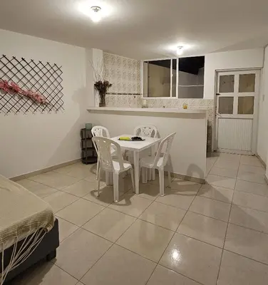 a kitchen with a table and chairs in a room at Apartamentos Santori in Cartagena de Indias