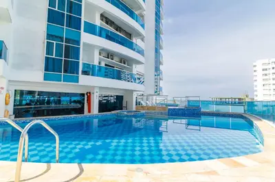 a swimming pool in front of a building at Apartamento Unik Cartagena Edificio Poseidón in Cartagena de Indias