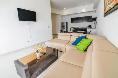 a living room with a couch and a tv at Apartamento Unik Cartagena Edificio Poseidón in Cartagena de Indias
