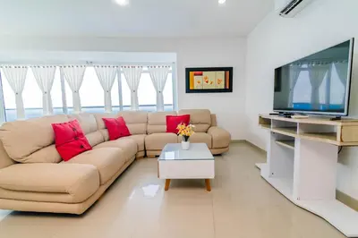 a living room with a couch and a flat screen tv at Apartamento Unik Cartagena Edificio Poseidón in Cartagena de Indias
