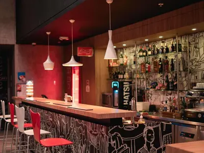 a bar in a restaurant with red chairs at ibis Cartagena Marbella in Cartagena de Indias
