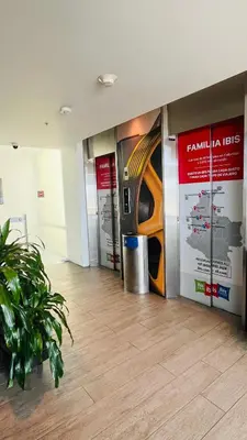 a hallway with posters on the wall in a building at ibis Cartagena Marbella in Cartagena de Indias