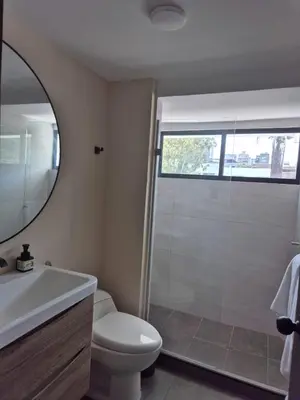 a bathroom with a shower and a toilet and a sink at Laureles del parque loft in Barranquilla