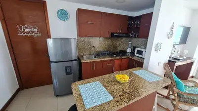 a kitchen with a counter with a bowl of fruit on it at Oceanfront apartment in Cartagena in Cartagena de Indias