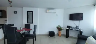 a living room with a table and a tv at Live Stay - Torres del Lago in Cartagena de Indias