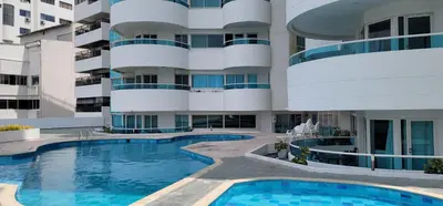 an exterior view of a building with two swimming pools at Live Stay - Torres del Lago in Cartagena de Indias