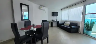 a living room with a dining room table and a couch at Live Stay - Torres del Lago in Cartagena de Indias