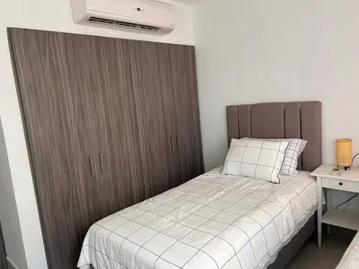 a bedroom with a bed with a large wooden cabinet at Cozy apartment Brand new in Cartagena de Indias