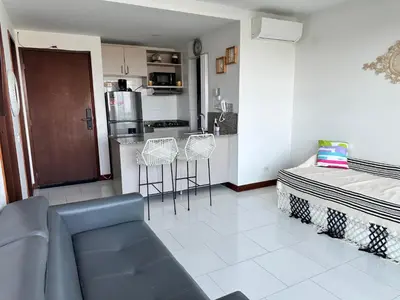 a living room with a couch and a kitchen at Morros la boquilla in Cartagena de Indias