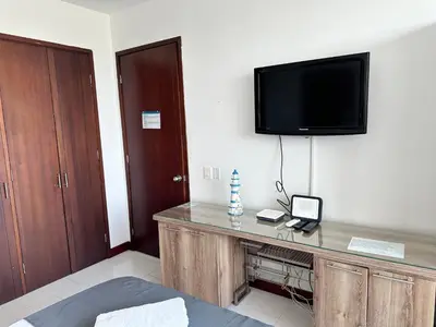 a room with a desk with a television on the wall at Morros la boquilla in Cartagena de Indias