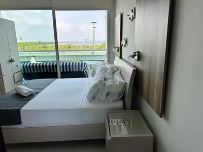 a bedroom with a bed with a view of the ocean at Morros la boquilla in Cartagena de Indias