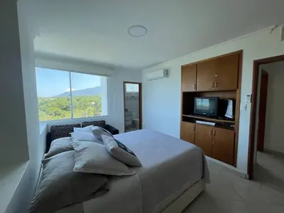 a bedroom with a bed with pillows and a window at Unwind in Santa Martas Oceanfront Retreat in Playa Dormida