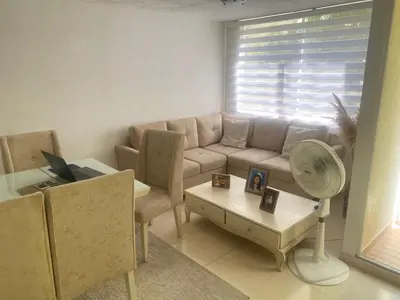 a living room with a couch and a table at Habitación en Villa Carolina con aire in Barranquilla