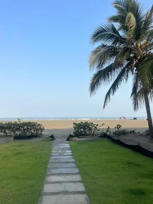 a pathway leading to a beach with a palm tree at Apartamento en la Boquilla Cartagena in Cartagena de Indias