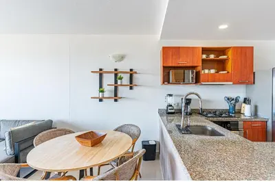 a kitchen with a wooden table and a counter top at Altamar, disfruta la mejor vista in Cartagena de Indias