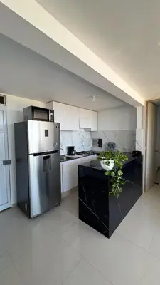 a large kitchen with a stainless steel refrigerator at Apartamento con Vista espectacular en Barranquilla in Barranquilla