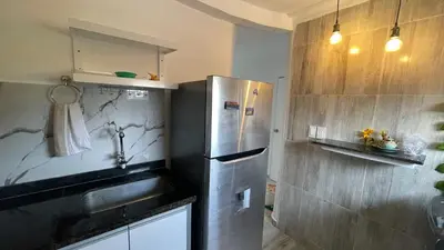 a kitchen with a stainless steel refrigerator and a sink at Apartamento Coveñas in Coveñas