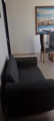a living room with a couch and a painting on the wall at Safarihostal in Cartagena de Indias