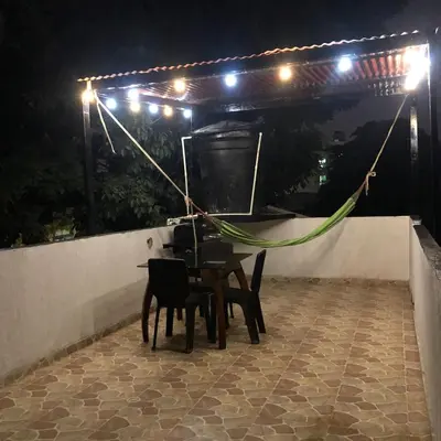 a table and chairs on a patio at night at Safarihostal in Cartagena de Indias