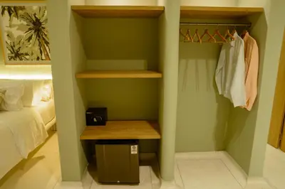 a bedroom with green walls and a closet with a wooden table at Terrazas Hotel Boutique in Cartagena de Indias