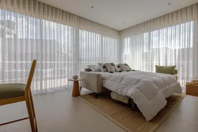a bedroom with a bed and large windows at Palmar del Mar in Cartagena de Indias