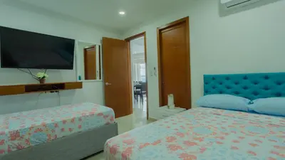 a bedroom with a large bed and a tv at Apartamento Vista Mar 1604 in Cartagena de Indias