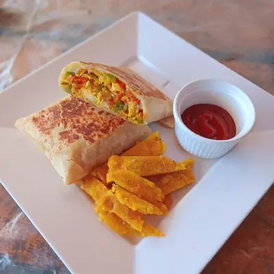 a sandwich and chips on a plate with ketchup at Tintipán Glamping in Tintipan Island